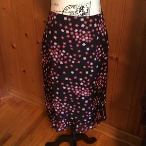 Harold’s knee length rayon skirt with bottom kick pleat.